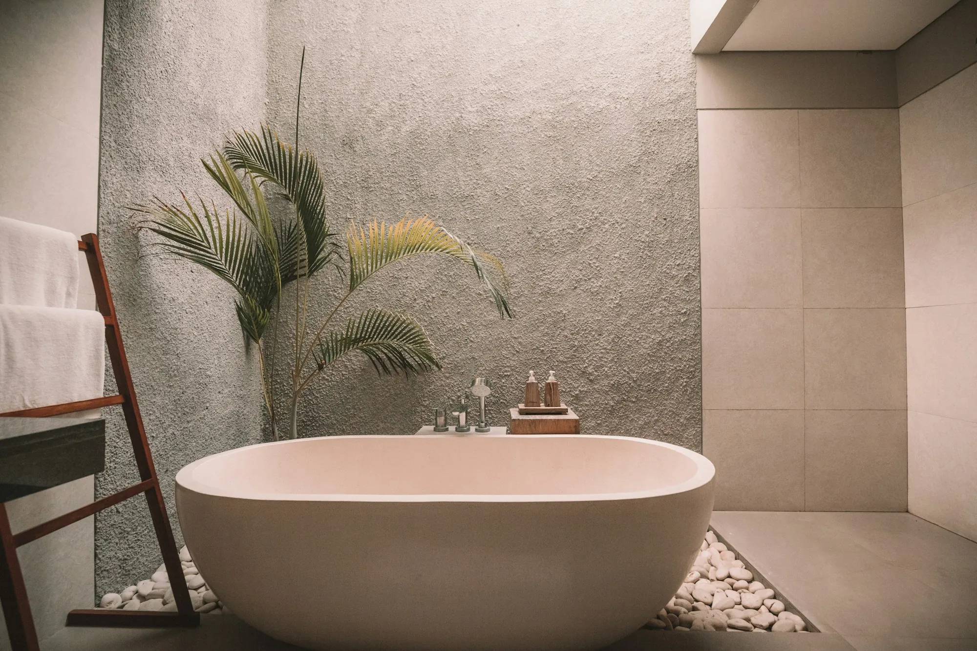 Bright bathroom with a tiled walk-in shower and a wood vanity