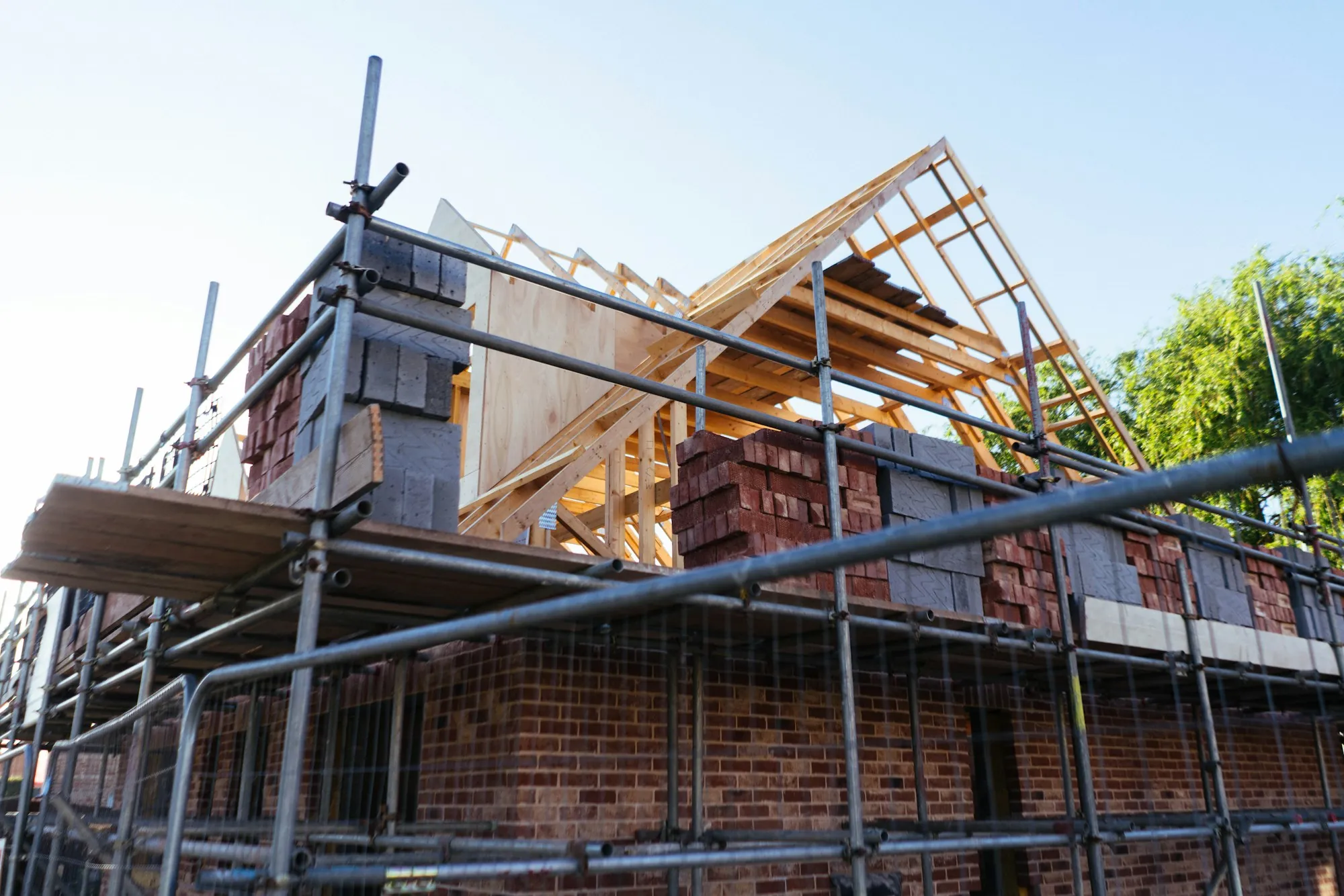 New single-story room addition attached to the back of a brick house