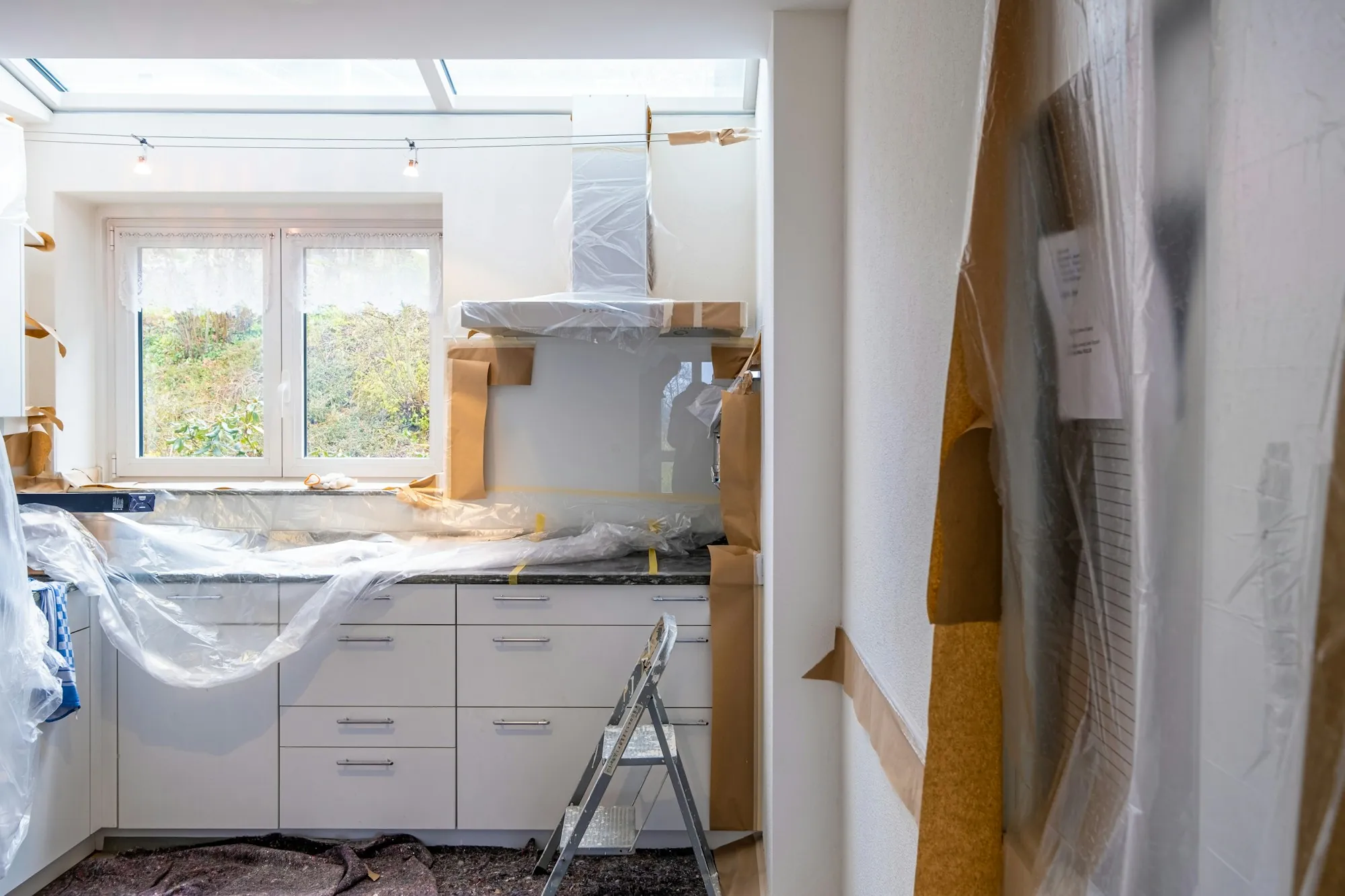 Renovated living room opening into a new kitchen with an island